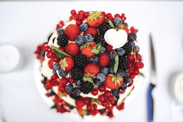 Top view close up of fruit wedding cake decorated with various berries at reception