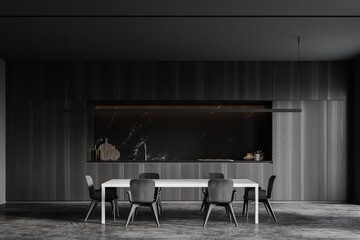 Grey kitchen interior with cabinets and table