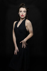 1940s woman wearing a black halter neck dress