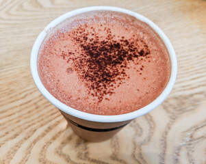 A cup of rich indulgent hot chocolate served in an environmentally friendly paper cup