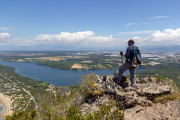 hiker on mountain peak with sea below in circeo national park