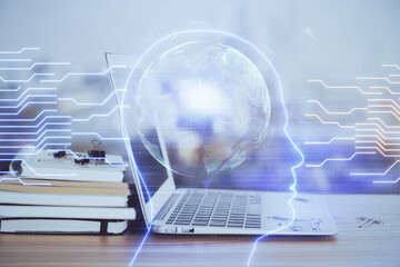 Multi exposure of work table with computer and brain hologram. Brainstorm concept.