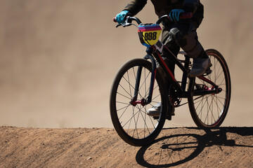 Fototapeta na wymiar BMX rider competing in the child class on the off-road circuit