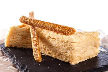 Two pieces of cake and sticks of sesame kozinak
