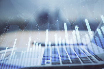 Stock market graph and table with computer background. Multi exposure. Concept of financial analysis.