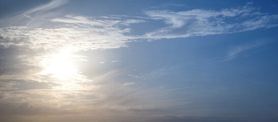 Naklejka na ściany i meble Sunset or sunrise on a blue sky with clouds.