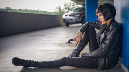Beautiful brunette sexy spy agent (killer or police) woman in leather jacket and jeans with a gun...