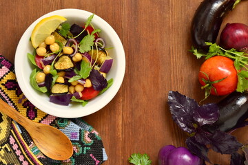 Eggplant Salad with Chickpeas and Fresh Vegetables, top view, copy space