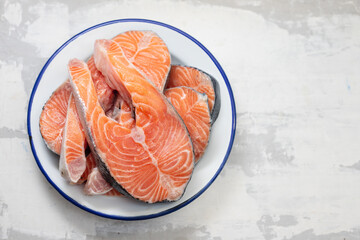 fresh raw salmon on the dish on ceramic background