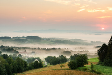 Fototapeta na wymiar Rolling Hills in Morning Fog at Sunrise in Coutryside in Poland