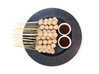  grilled meat ball with cups of sweet spicy sauce on black plate isolated on white background.
