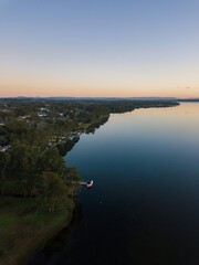 Fototapeta premium Aerial view along Budgewoi Lake, Central Coast, NSW, Australia.