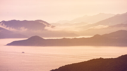 Fototapeta premium Hong Kong ocean sunset mountain heaven background nautical vessel cargo ship industry