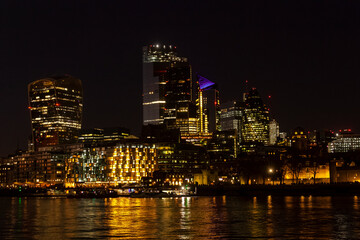 Fototapeta na wymiar A night time view of the City of London from across the Thames