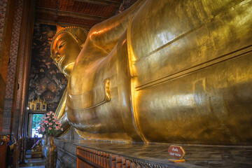 Bangkok, Thailand - August 14, 2020: Giant reclining Buddha on the famous Buddhist temple Wat Pho. Bangkok, Thailand.