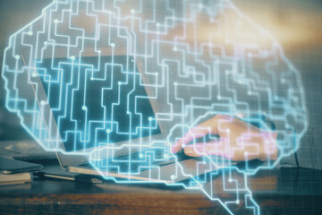 Man typing on keyboard background with brain hologram. Concept of big Data. Double exposure.