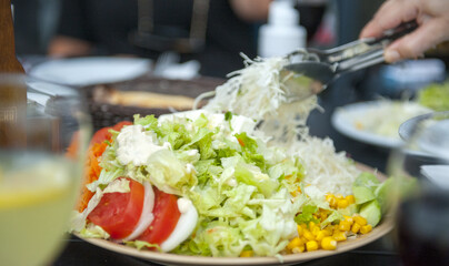 Salad with greens, tomatoes, cabbage, onions and corn