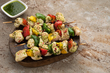 stick bbq chicken with vegetable sauce and bell pepper on wood