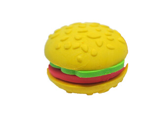 Selected focused on a fake burger made from colourful toy soft rubber isolated on white background. 