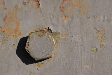 Detail of an old surface with exfoliated paint and rivets on military equipment. Military background. High quality photo