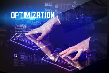 Hand touching digital table with OPTIMIZATION inscription, new age security concept