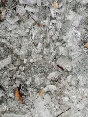 broken glass into small crumbs lying on the ground