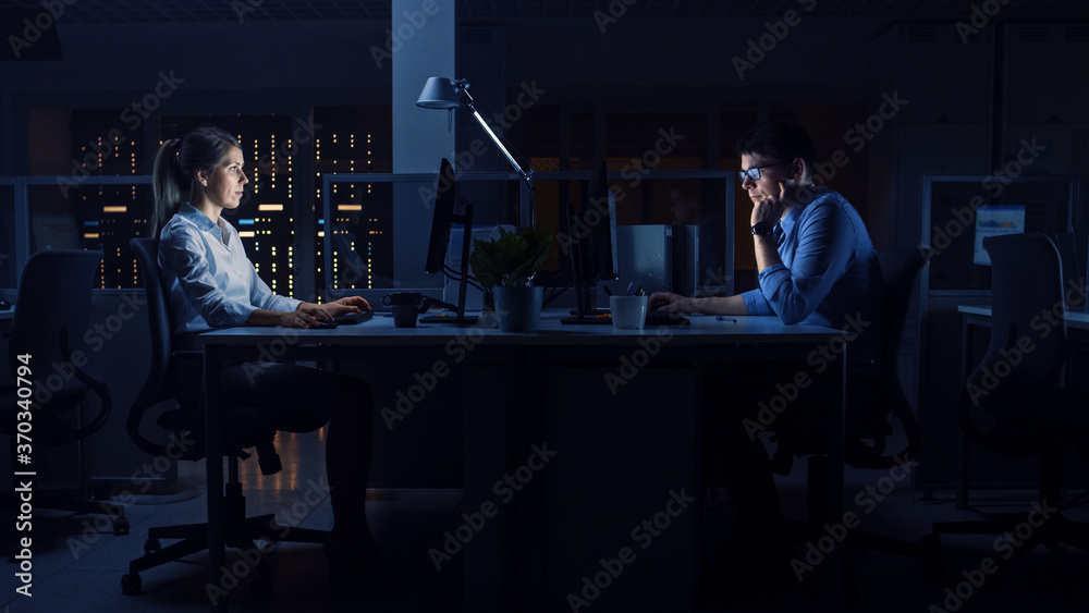 Poster Working Late at Night in the Office: Workers Use Desktop Computers, Analyzing, Using Documents, Solving Problems, Finishing Important Project. Diligent Ambitious Young Businesspeople. Side View