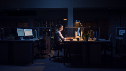 Working Late at Night in the Office: Businesswoman Uses Desktop Computer, Analyzing, Using...