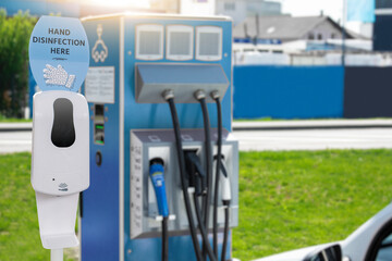 Contactless disinfection for hands on a electric vehicles charging station during the coronavirus pandemic	