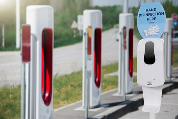 Contactless disinfection for hands on a electric vehicles charging station during the coronavirus pandemic	