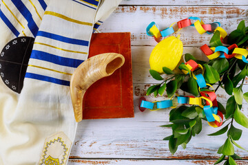 Jewish ritual festival of Sukkot in the jewish religious symbol over paper colorful chain garland...