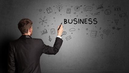 businessman drawing a creative idea sketch with BUSINESS inscription, business strategy concept