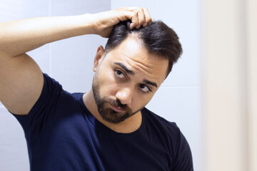 Portrait of a man worried about hair loss