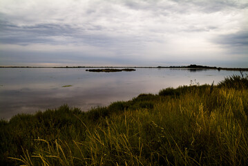Fototapeta na wymiar Villeneuve lès Maguelone laguna at dawn with cloudy sky
