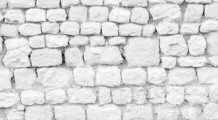 White texture of an old wall made of exposed stones - old vintage texture design - large image in high resolution	