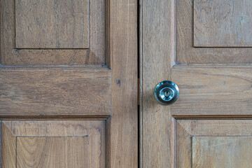 Wooden doors with steel knobs that are closed