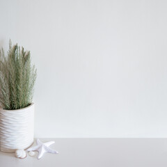 Wall mockup with beach/ocean theme decoration on white surface. Copy space.