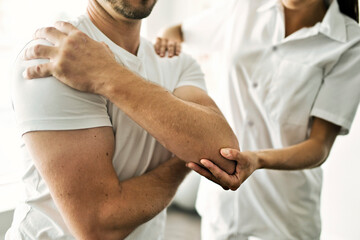 physiotherapist doing treatment with patient in bright office