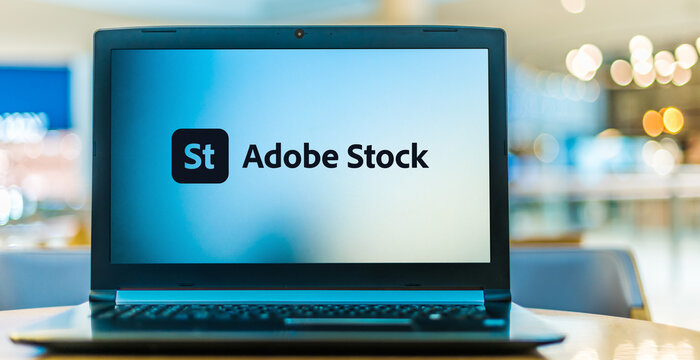 Laptop computer displaying logo of Adobe Stock