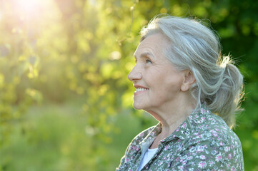 Portrait of senior beautiful woman posing in park
