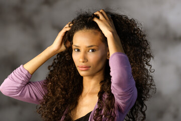 Cute attractive Afro American girl touching hair