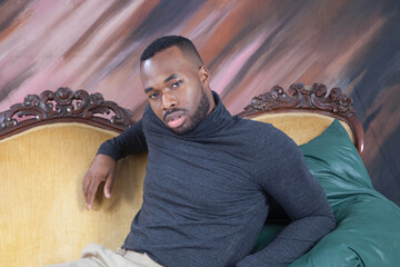 Handsome black man sitting thoughtfully