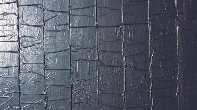 Water reservoir construction site with newly installed plastic lining sheets, Aerial view.