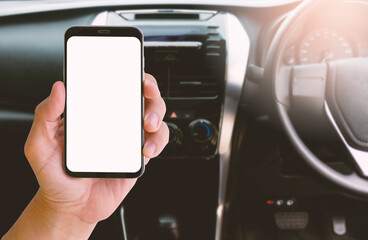 Smartphone with blurred background of car steering wheel