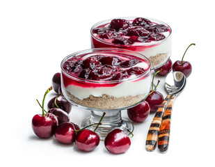 Homemade cheesecake with cherry jam in a glass dessert bowl isolated on white