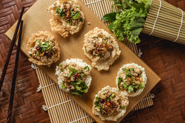 Creative food. Puffed rice and spicy minced pork salad on topping.