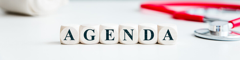 Banner, dices with word Agenda, medical office or clinic workplace background