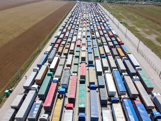 Trucks standing in line at the port to unload grain. Transportation and logistics concept.