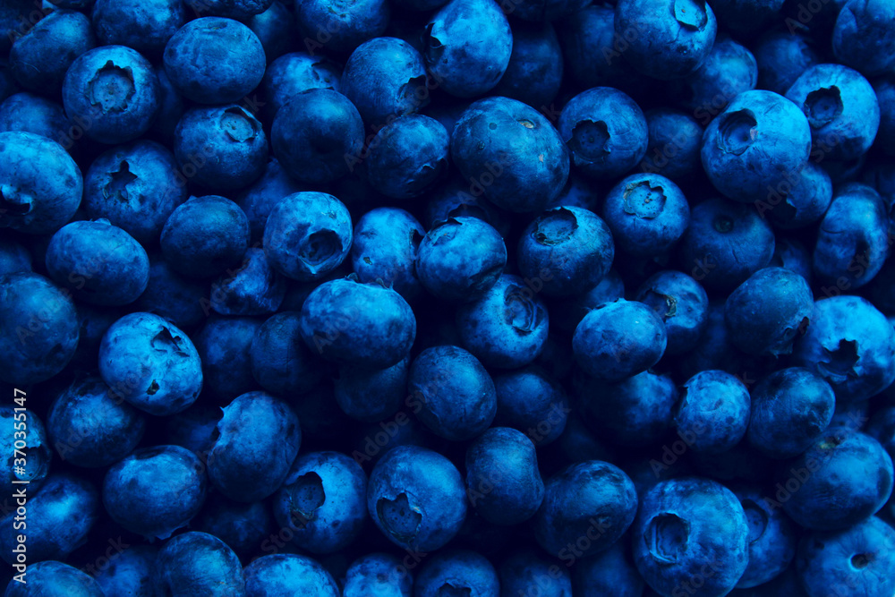 Wall mural blurry image of blueberries. berries background. abstract food background.