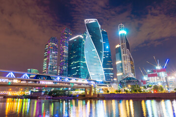 Fototapeta na wymiar Moscow skyline panorama at night with colorful lights reflections on the surface of the river Moskva. Modern skyscrapers for business and life style in Russia.